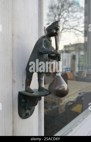 Door knocker glassblower figure Stock Photo
