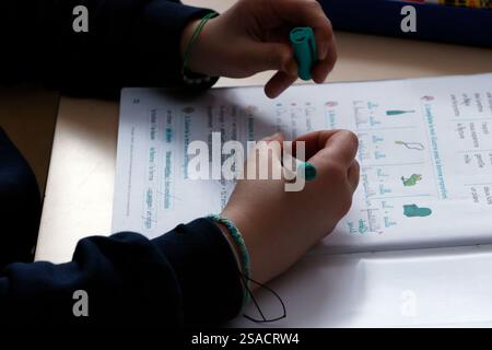 Primary school classroom with a pupil writing is work.   France. Stock Photo