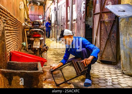 Craftsman at work outside a workshop in Marrakesh, Morocco Stock Photo