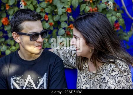 Young European man and woman sitting and smiling in Marrakesh, Morocco Stock Photo