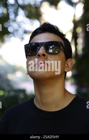 Young European man with sunglasses looking up in Marrakesh, Morocco Stock Photo