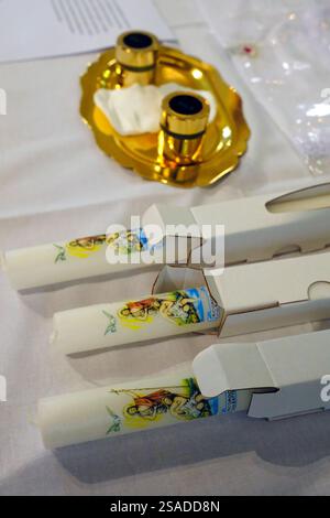 Baptism liturgical objects ready on table at church. Book, manuterge ...