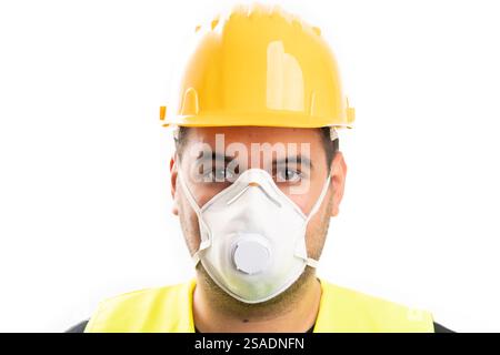 Close-up of male construction worker with yellow helmet wearing work protective mask as renovating concept isolated on white background Stock Photo