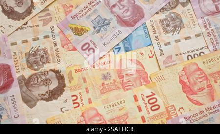 Mexican pesos banknotes scattered, showcasing various designs and denominations from the bank of mexico. Stock Photo