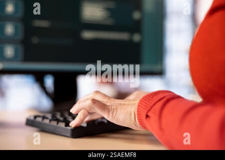 Focused woman working with an AI chatbot on her desktop pc, offering real time assistance and powerful online tools. Advanced system displays how machine learning provides support. Stock Photo