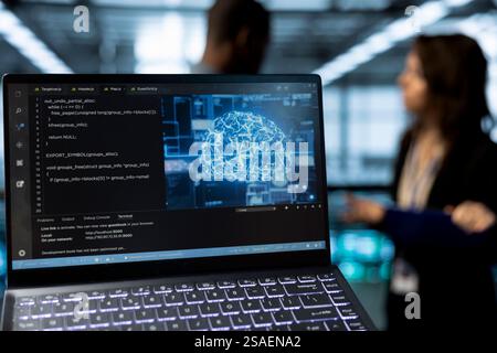 Focus on laptop used by data center system administrators using artificial intelligence neural networks. Close up of AI programming language on notebook screen used by server farm employees Stock Photo