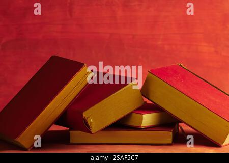 Row of red books on red grungy background, reading, learning, education knowledge is power or home office concept Stock Photo