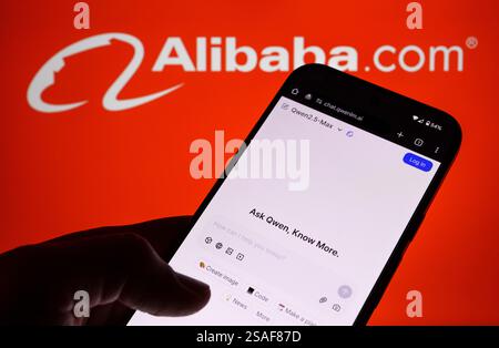 Qwen AI interface seen on the screen of smartphone hold in hand and blurred Alibaba logo on the background. Stafford, UK, January 29, 2025 Stock Photo