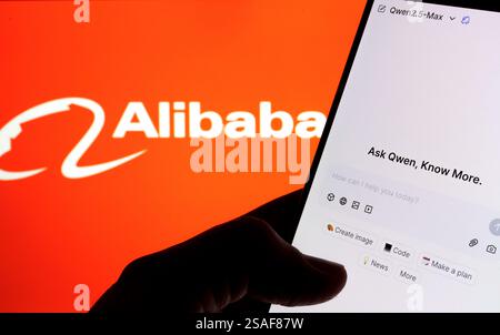 Qwen AI interface seen on the screen of smartphone hold in hand and blurred Alibaba logo on the background. Stafford, UK, January 29, 2025 Stock Photo