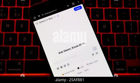 Alibaba's Qwen AI interface seen on the screen of smartphone placed on keyboard lit in red. Concept. Stafford, UK, January 29, 2025 Stock Photo