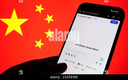 Qwen AI interface seen on the screen of smartphone and blurred flag of China on the background. New AI model from Alibaba. Stafford, UK, January 29, 2 Stock Photo