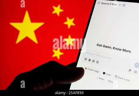 Qwen AI interface seen on the screen of smartphone and blurred flag of China on the background. New AI model from Alibaba. Stafford, UK, January 29, 2 Stock Photo