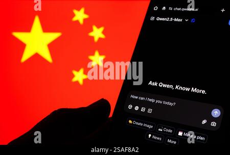 Qwen AI interface seen on the screen of smartphone and blurred flag of China on the background. New AI model from Alibaba. Stafford, UK, January 29, 2 Stock Photo