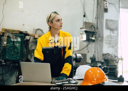 caucasian women engineer worker working at design desk working in heavy industry Stock Photo
