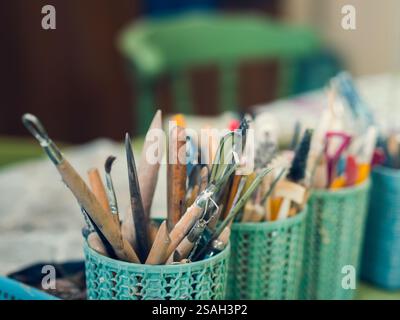 Tools in the pottery studio. Stacks, scallops, brushes. Devices for working with ceramics. Stock Photo
