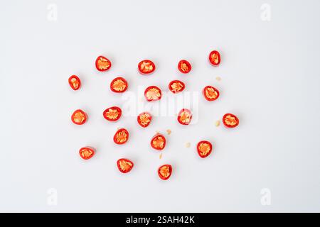 Top view set of fresh red chili pepper slices or pieces scattering is isolated on white background Stock Photo