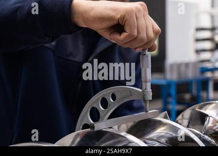 Professional quality control inspector conduct safety inspection on steel machinery and manufacturing process. Factory engineer or operator make Stock Photo