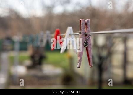 Plastic Clothespin on a hanger. Colored old cloth clips on a cloth rope Stock Photo