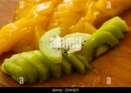 slices of kiwi and slice mango on the desk. Stock Photo