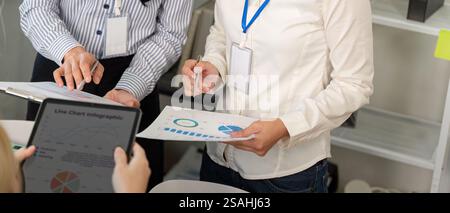 Diverse business team analyzing charts and data in a collaborative meeting. Stock Photo