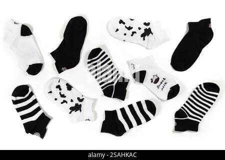 black and white socks on a white background. View from above. Many different socks for cold seasons. Socks are scattered on a bright background. Cloth Stock Photo