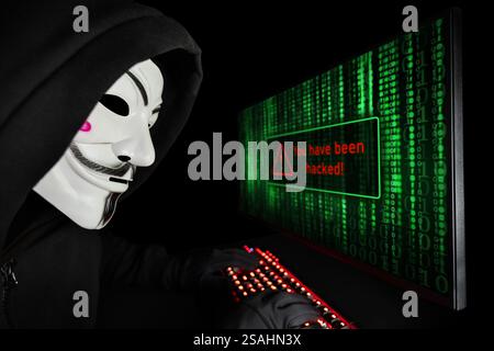 Dnipro. Ukraine. 03 feb 2024: Hacker with anonymous mask with a computer. You have been hacked. Stock Photo