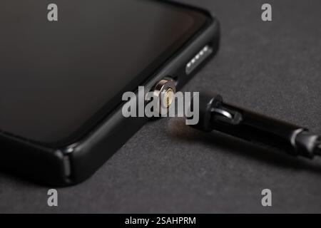 Magnetic cable for charging smartphone, close up Stock Photo