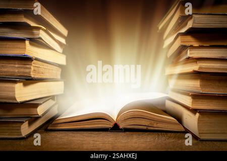 Old Book With Magic Lights On Vintage Table. Stock Photo