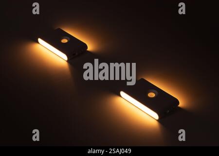 Two small solar night led light with motion sensor on wall Stock Photo