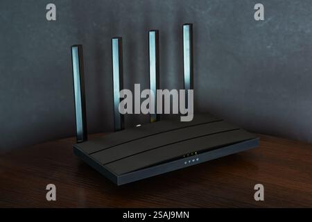 Wi-Fi router on black wooden table in room.. Stock Photo