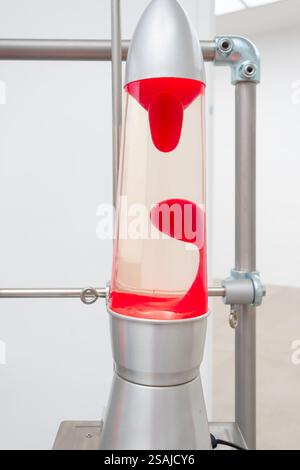 Stylish lava lamp with red bubbles on a background of laboratory equipment Stock Photo