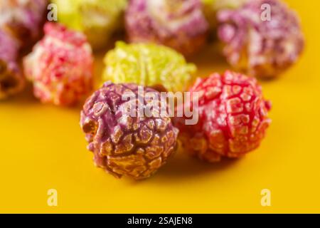 Colorful popcorn on yellow background close up. Stock Photo