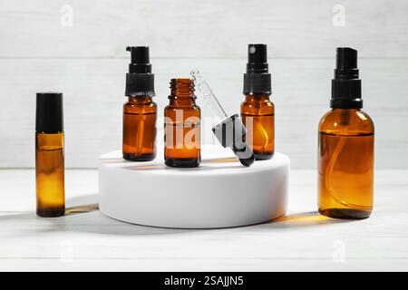 various amber glass bottles for cosmetics, natural medicine, essential oils or other liquids on a white background. Stock Photo