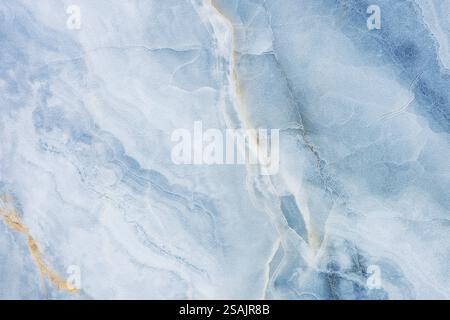 An abstract fluid art painting featuring swirling shades of blue and white, creating a marble-like texture. Stock Photo