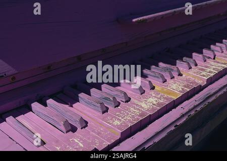 Old vintage grand piano keys painted purple close-up Stock Photo