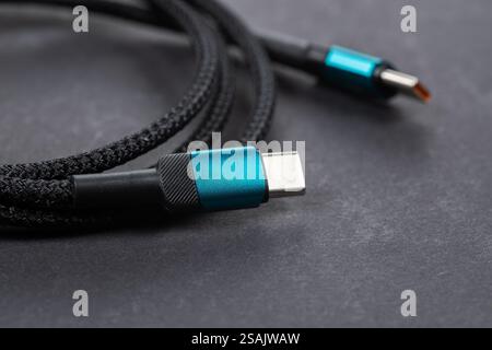 USB Type-C cable. Mobile data cable. Phone usb connector on dark background. usb cord charger, usb cable. Stock Photo