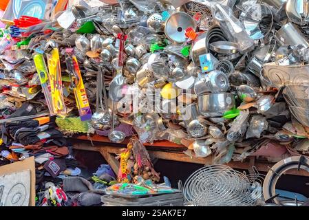 A huge pile of kitchenware, pots, pans, and accessories, randomly stacked on one another for customers to choose from. Stock Photo