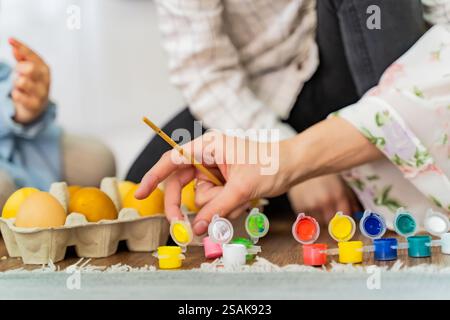Easter background, Family paints Easter eggs with colorful paints. No faces, template Stock Photo