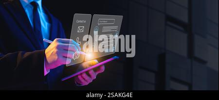 A businessman holds a tablet displaying a holographic chat interface with a robot icon, symbolizing AI-driven communication. Represents the use of art Stock Photo