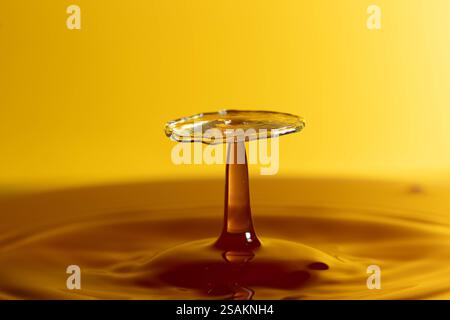 Splashart water collision on yellow background Stock Photo