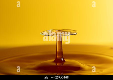 Splashart water collision on yellow background Stock Photo