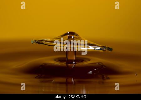 Splashart water collision on yellow background Stock Photo