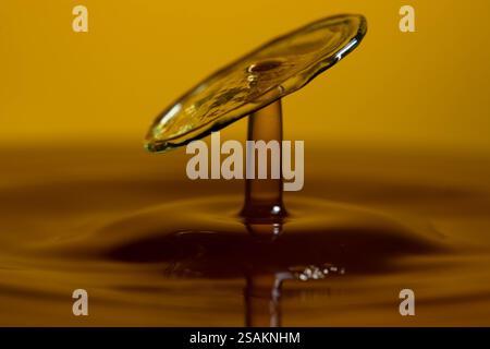 Splashart water collision on yellow background Stock Photo