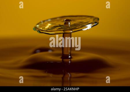 Splashart water collision on yellow background Stock Photo