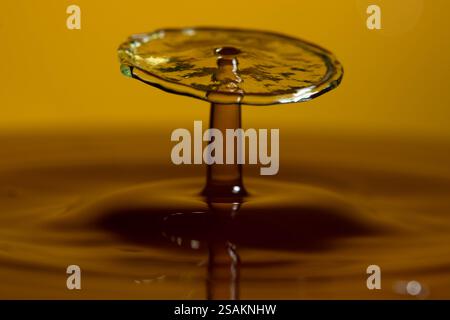 Splashart water collision on yellow background Stock Photo
