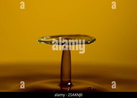 Splashart water collision on yellow background Stock Photo