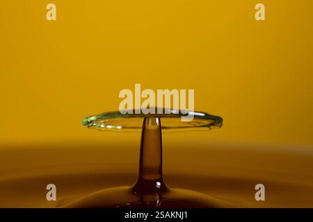 Splashart water collision on yellow background Stock Photo