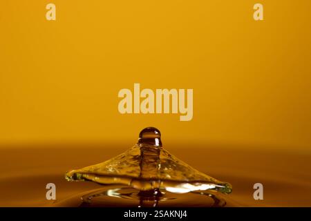Splashart water collision on yellow background Stock Photo