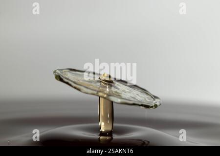 High-speed photograph capturing the dynamic collision of water droplets, creating a vibrant splash frozen in motion Stock Photo
