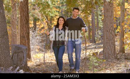 Active Mature Loving Couple Outdoors Enjoying Autumn Or Fall Walk In Forest Stock Photo